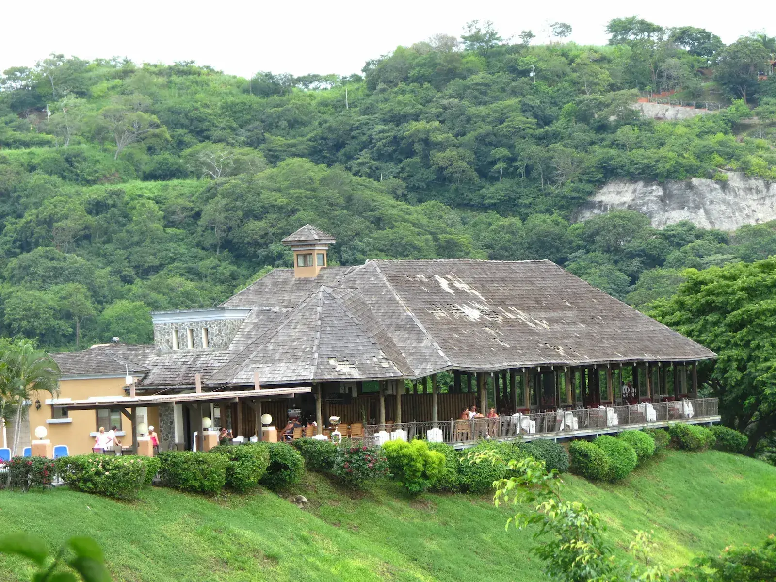 Rustic Costa Rican hotel surrounded by lush tropical greenery