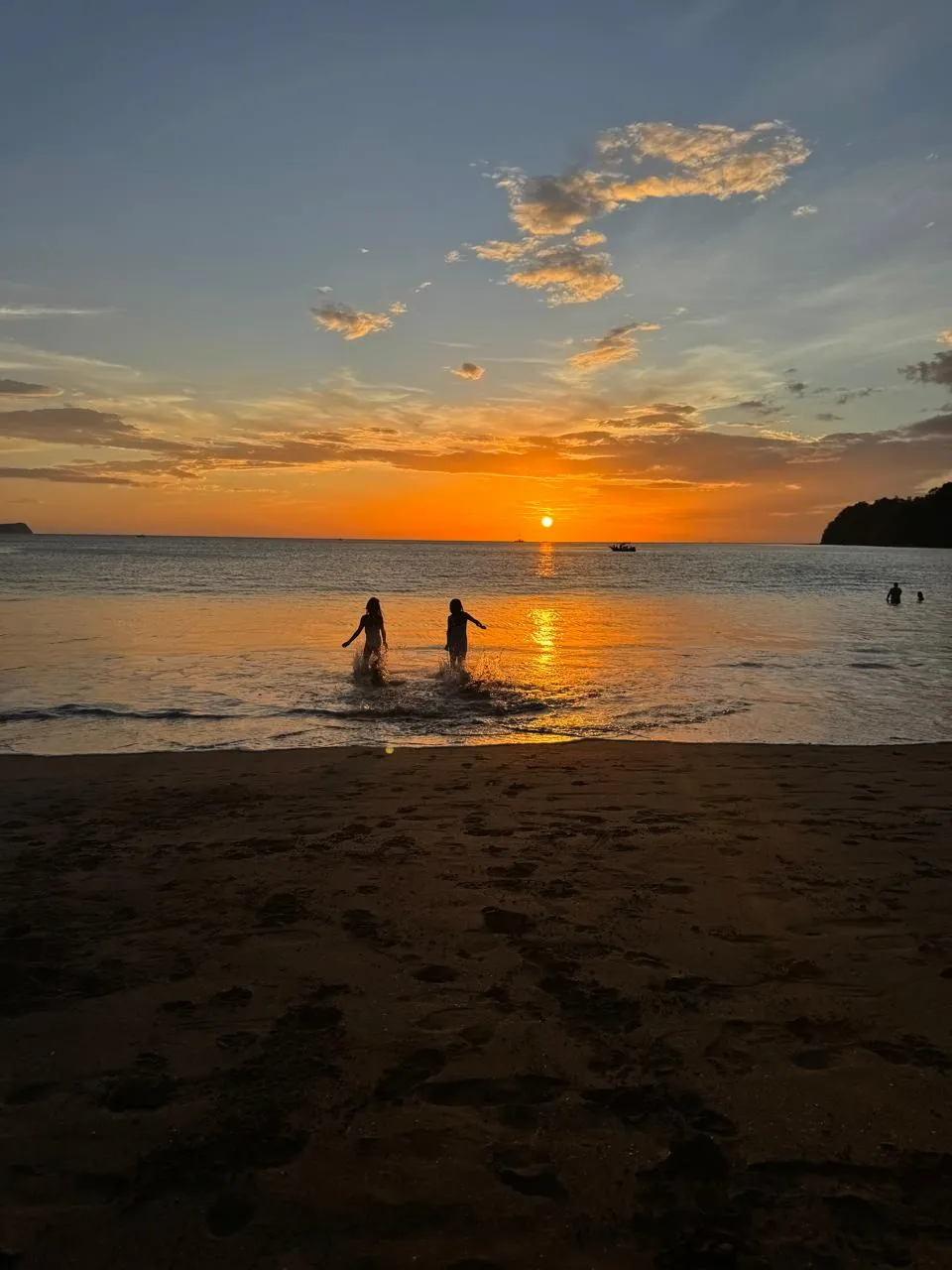 Children enjoying a calm beach at sunset in Papagayo, Costa Rica