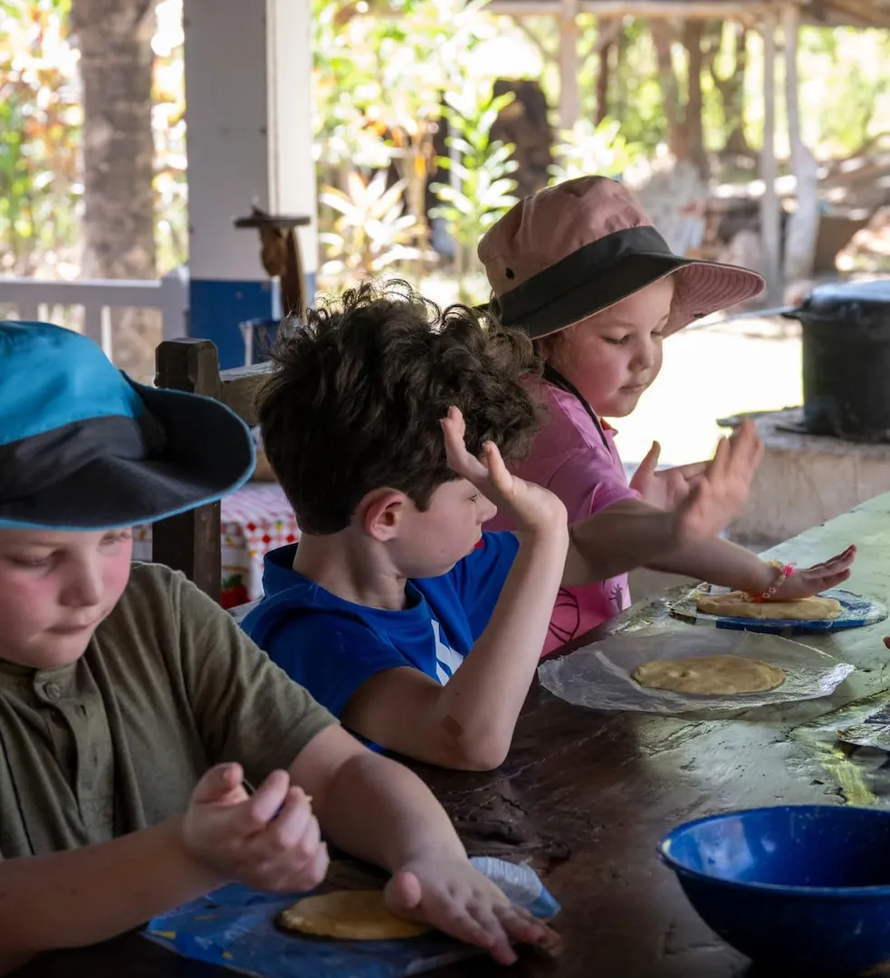 Children participating in a hands-on cooking activity during a family-friendly tour in Costa Rica.